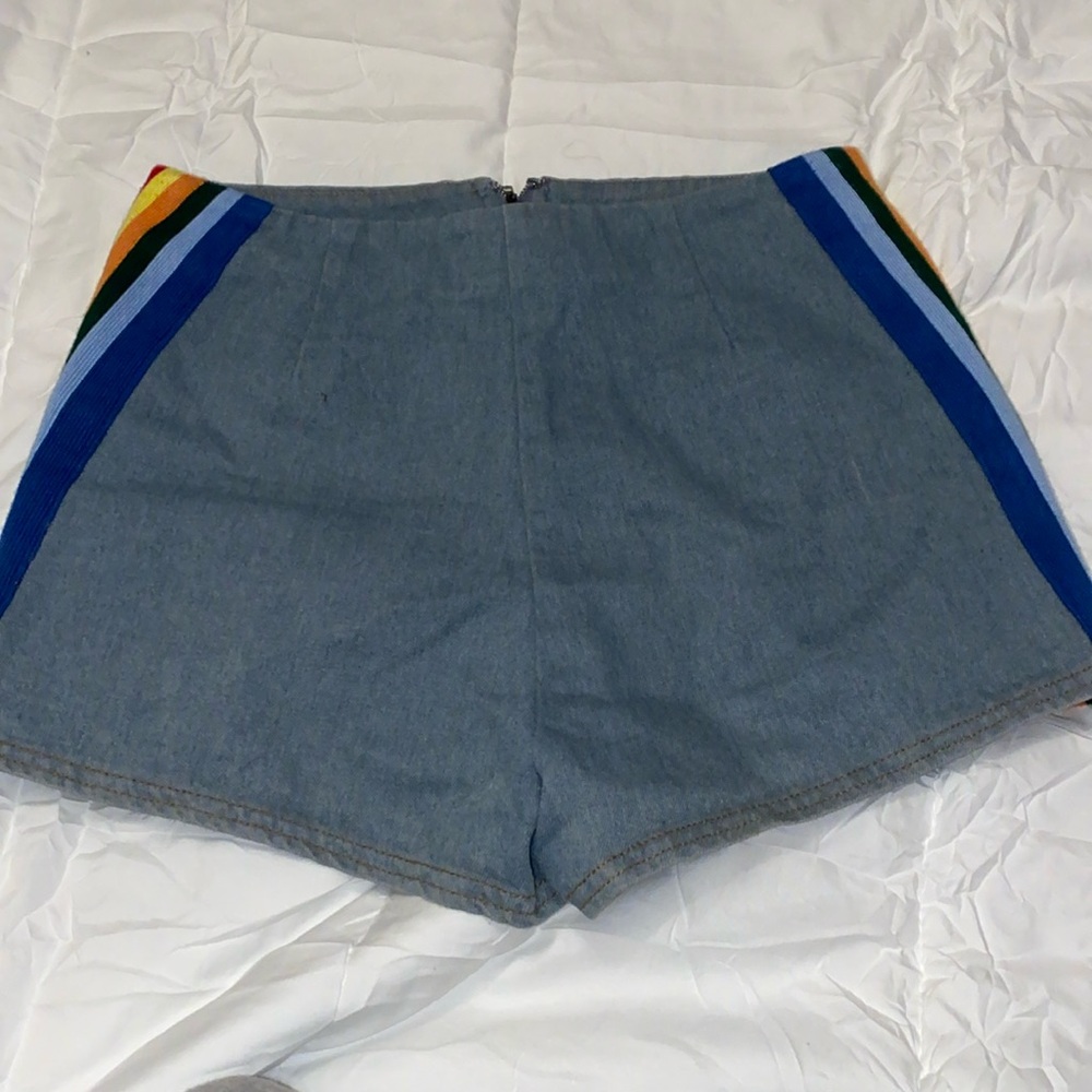 Denim shorts with rainbow stripes along the sides